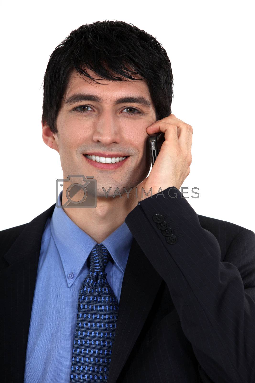 Royalty free image of Businessman talking on his mobile phone by phovoir