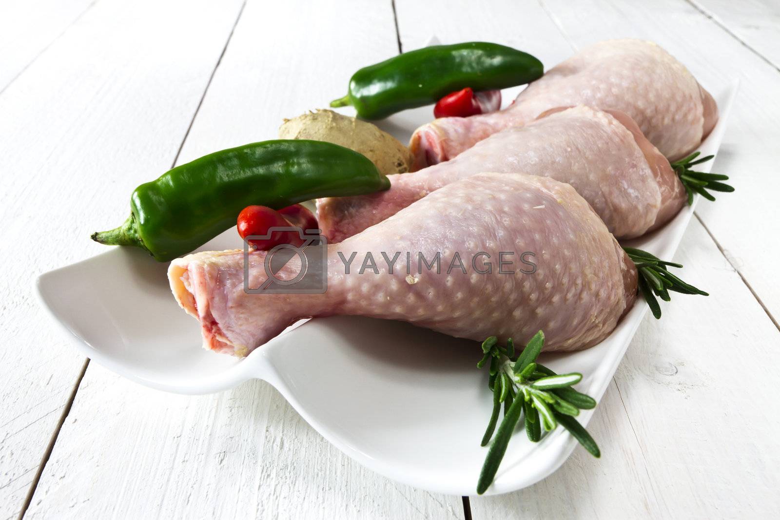 Royalty free image of Fresh chicken drumsticks by caldix