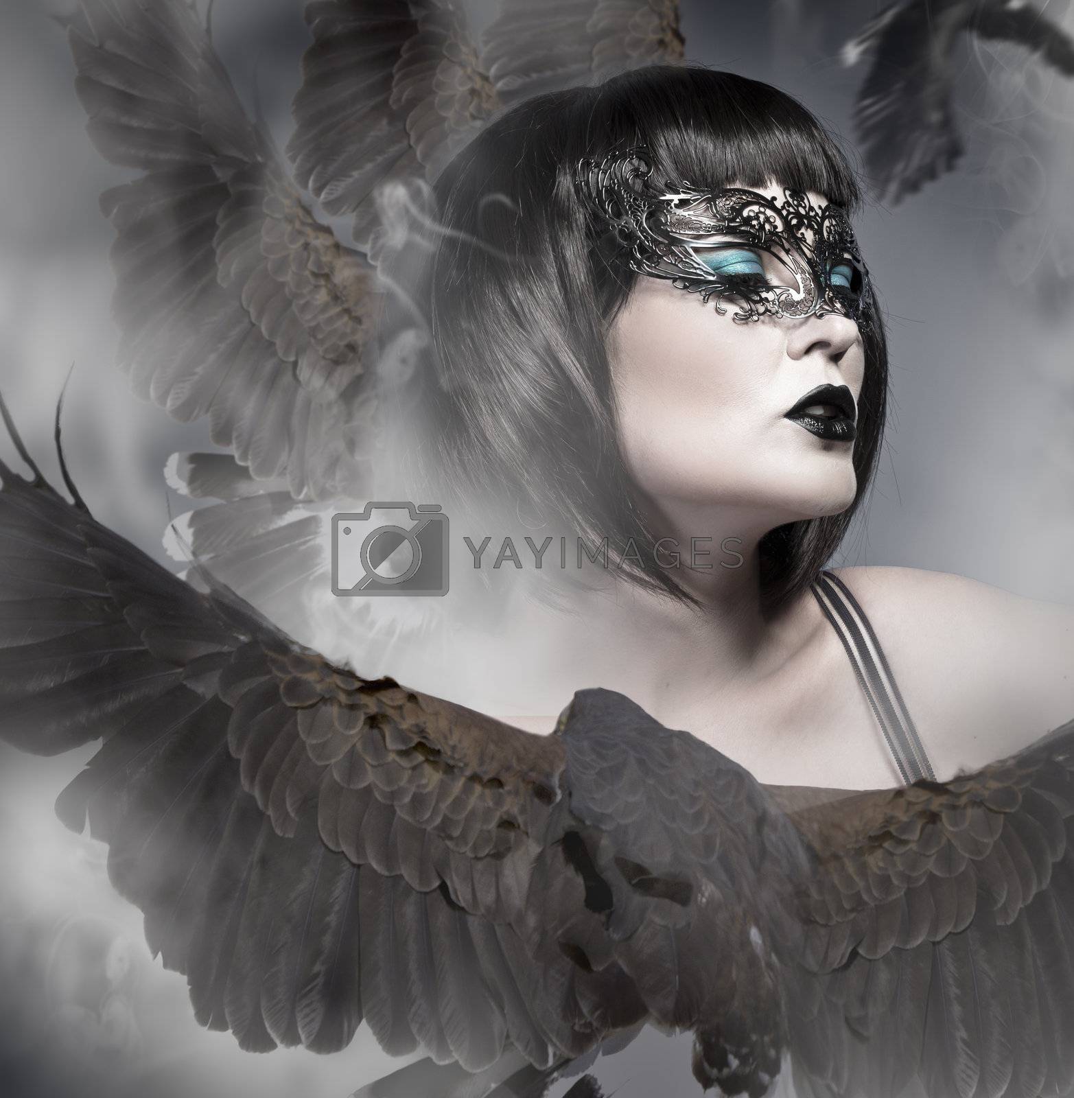 Royalty free image of Portrait of a beautiful woman wearing a venetian mask with big e by FernandoCortes