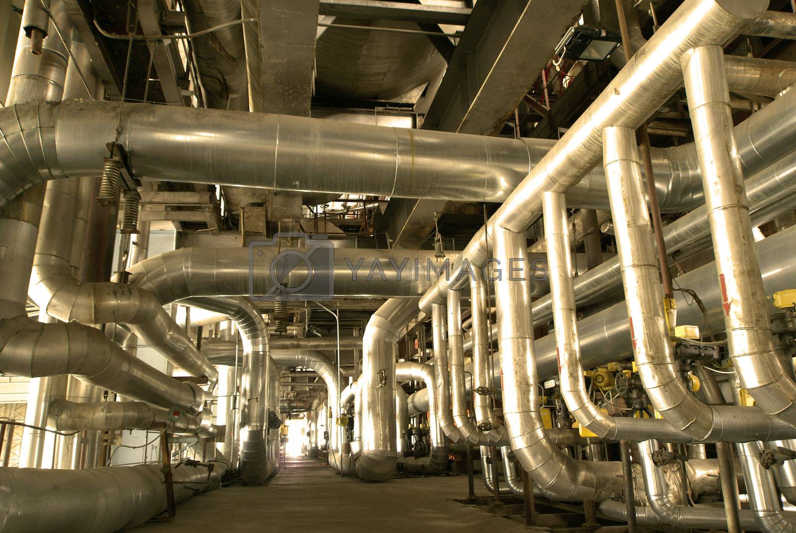 Royalty free image of Industrial zone, Steel pipelines and cables in yellow tones by nostal6ie