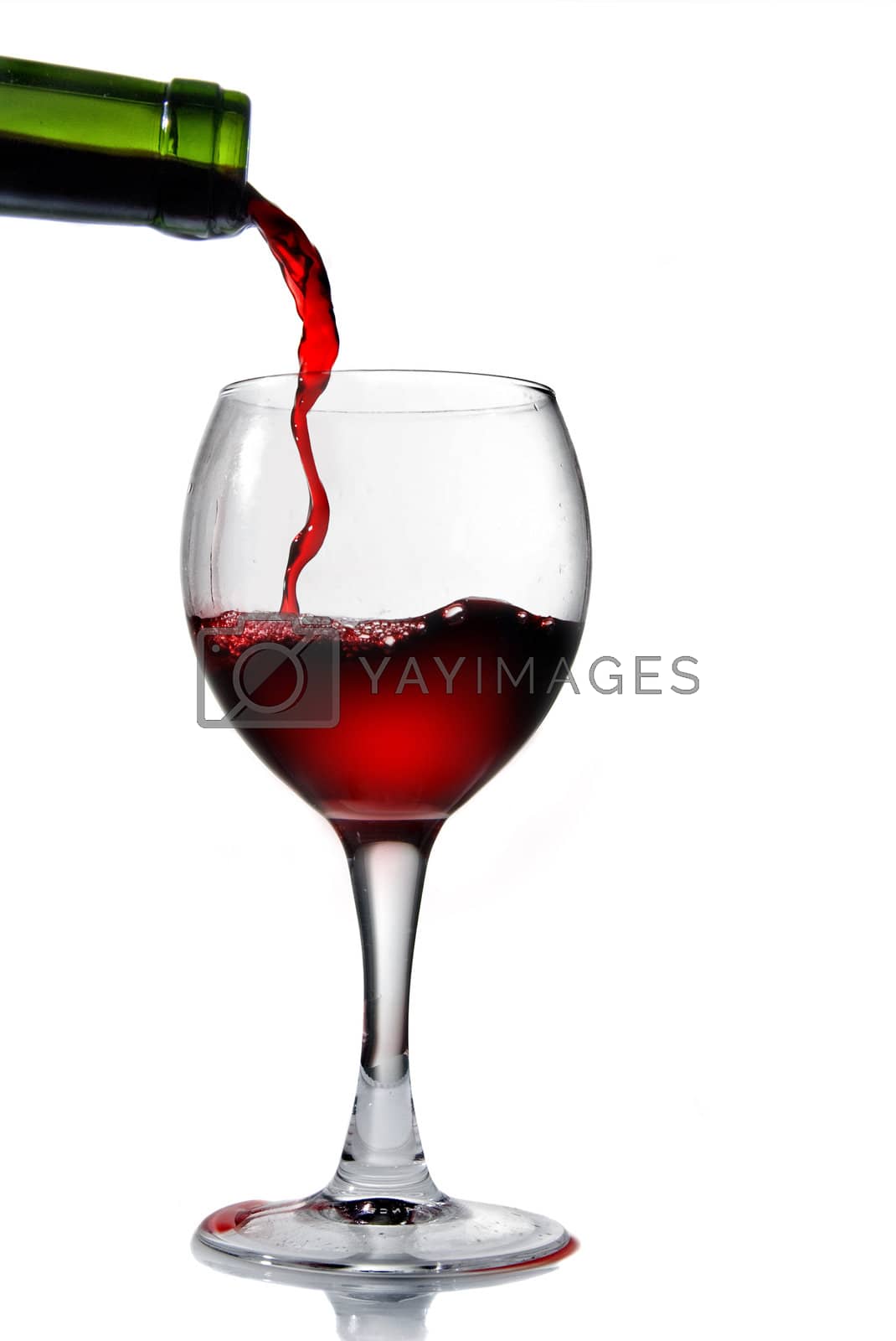 Royalty free image of Pouring red wine in goblet isolated on white by artjazz