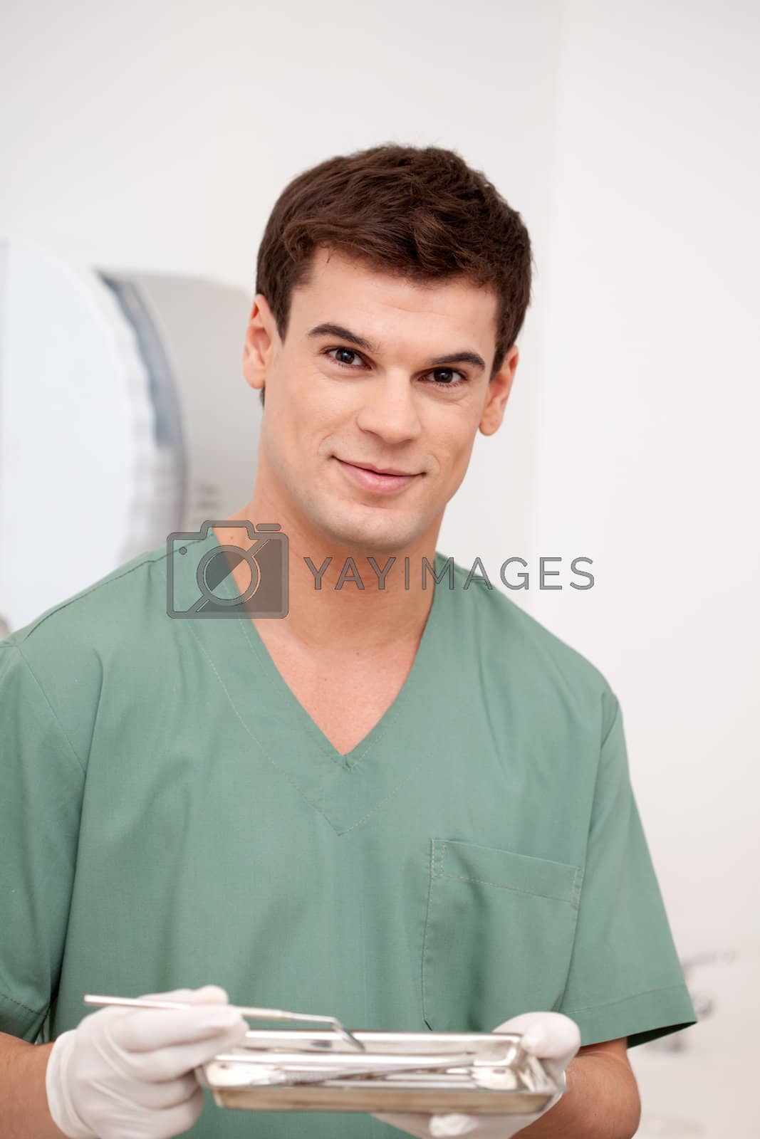Royalty free image of Dentist Man Portrait with a Smile by leaf