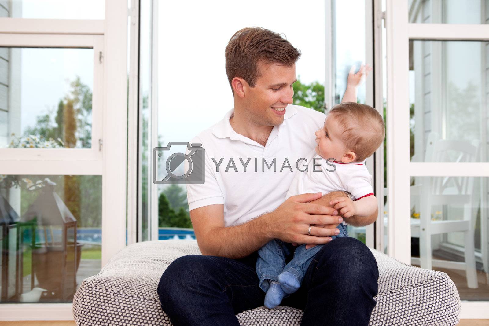 Royalty free image of Father and Son by leaf