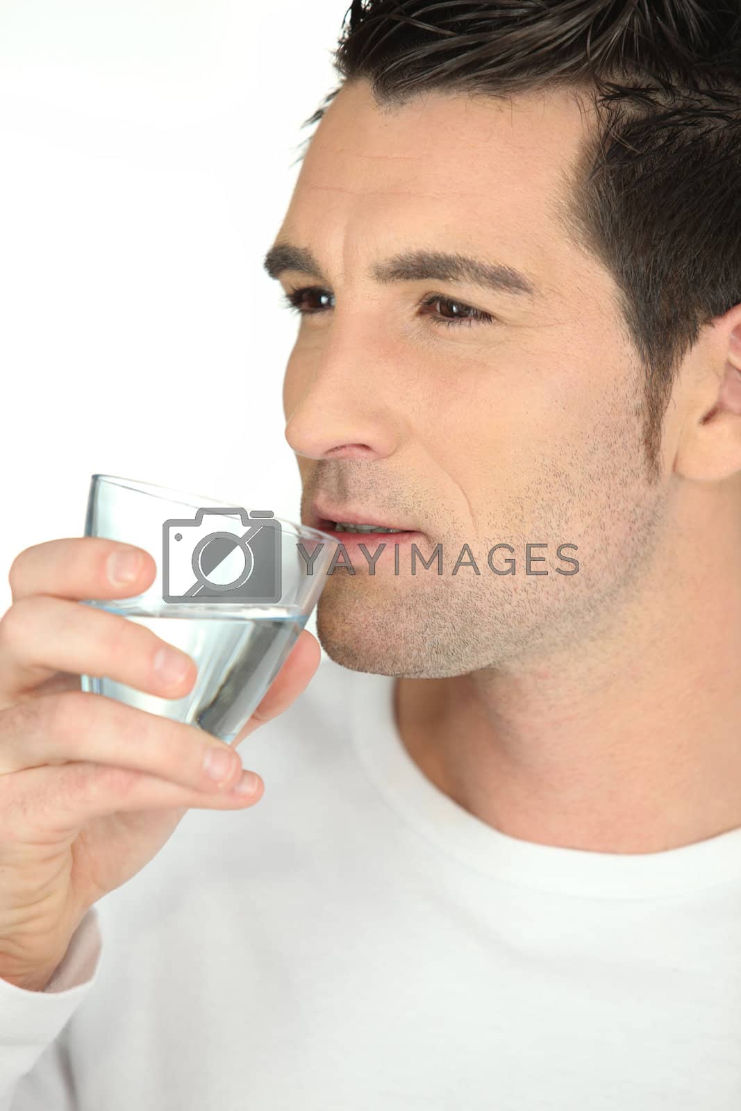 Royalty free image of bust shot of man drinking glass of water by phovoir