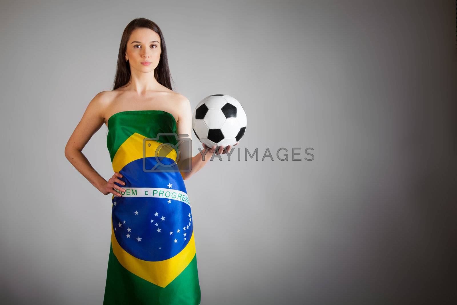 Royalty free image of woman in the Brazilian flag and soccer ball by TpaBMa