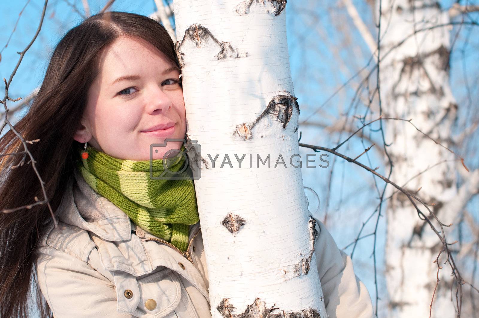 Royalty free image of Beautiful girl in green over tree and blue sky by markin