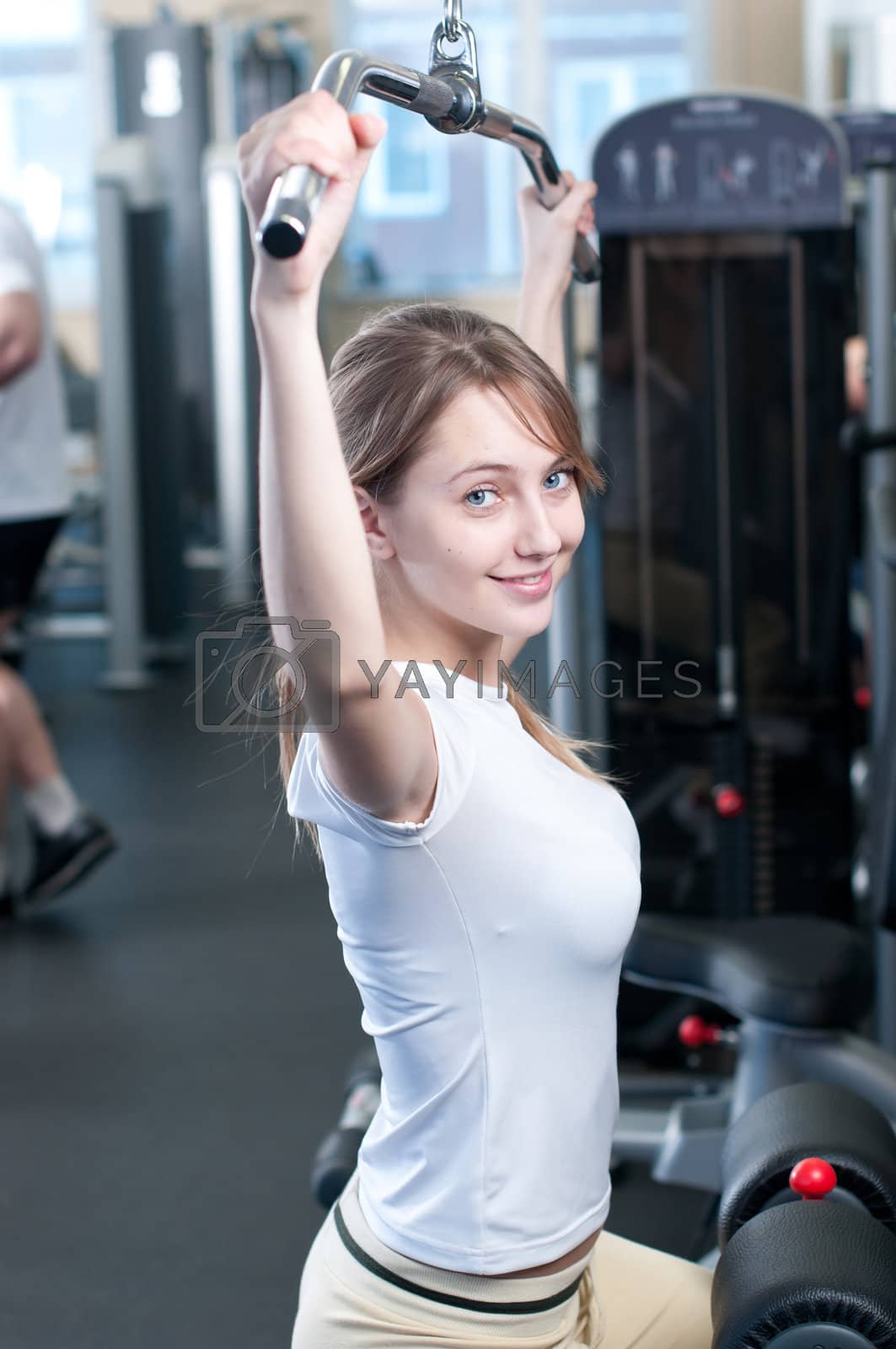 Royalty free image of Powerful casual woman lifting weights in gym by markin