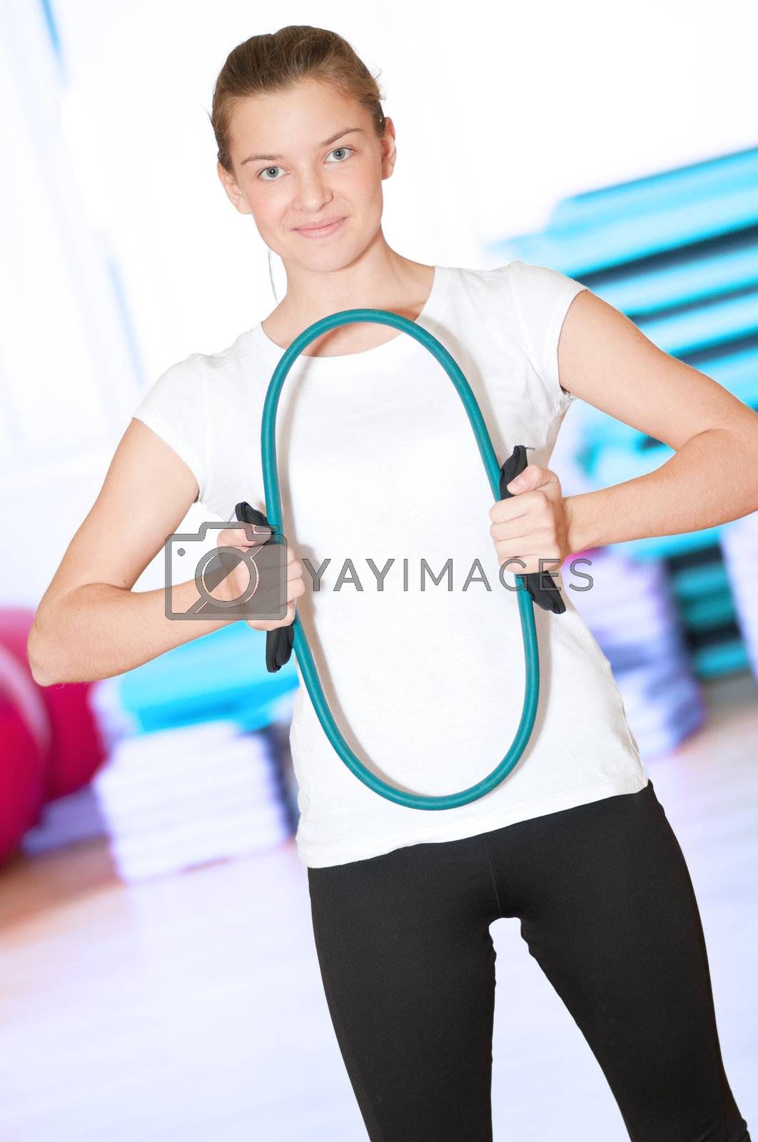 Royalty free image of Woman doing fitness exercise at sport gym by markin