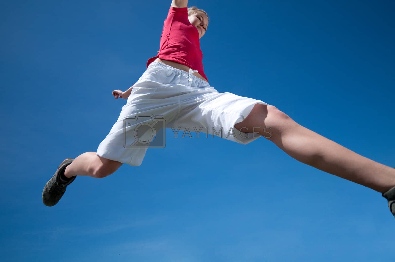 Royalty free image of Beautiful woman jump into sky by markin