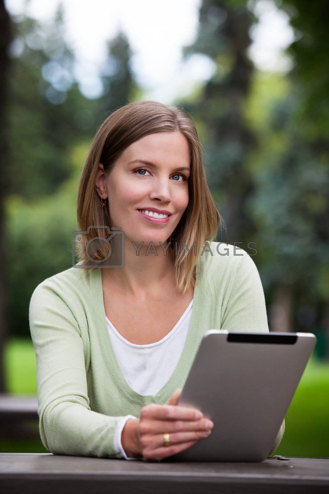 Royalty free image of Woman holding Digital Tablet by leaf