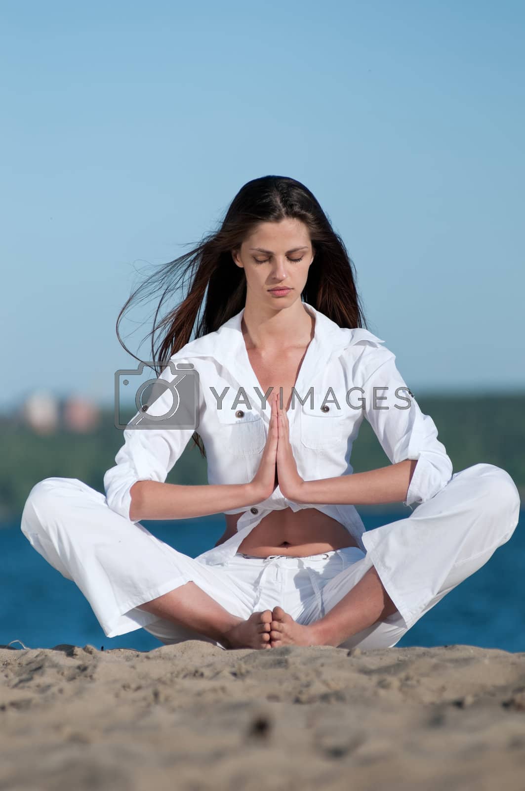 Royalty free image of Woman practicing yoga on the beach  by markin
