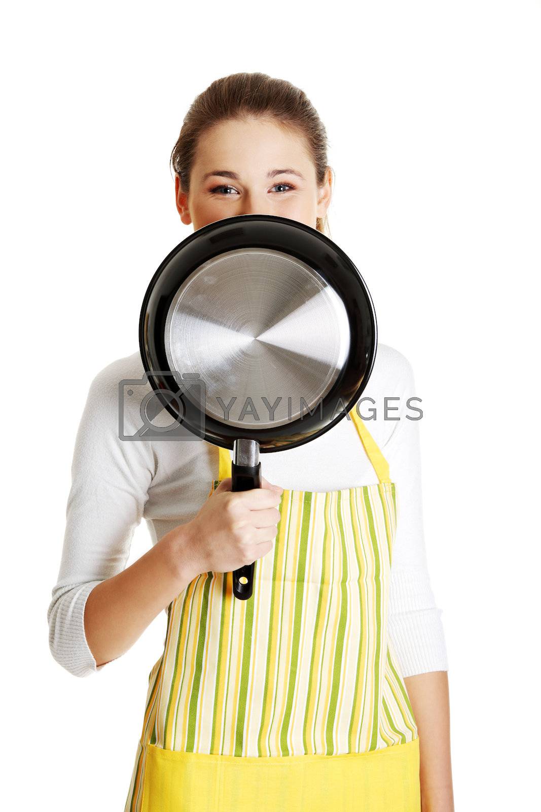 Royalty free image of Teen girl dressed in apronwith frying pan by BDS