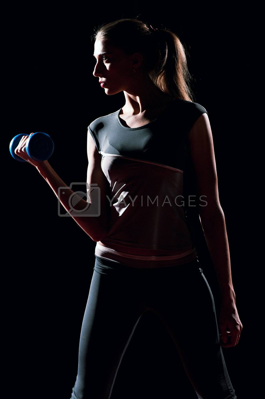Royalty free image of Beautiful sport woman doing power fitness exercise by markin