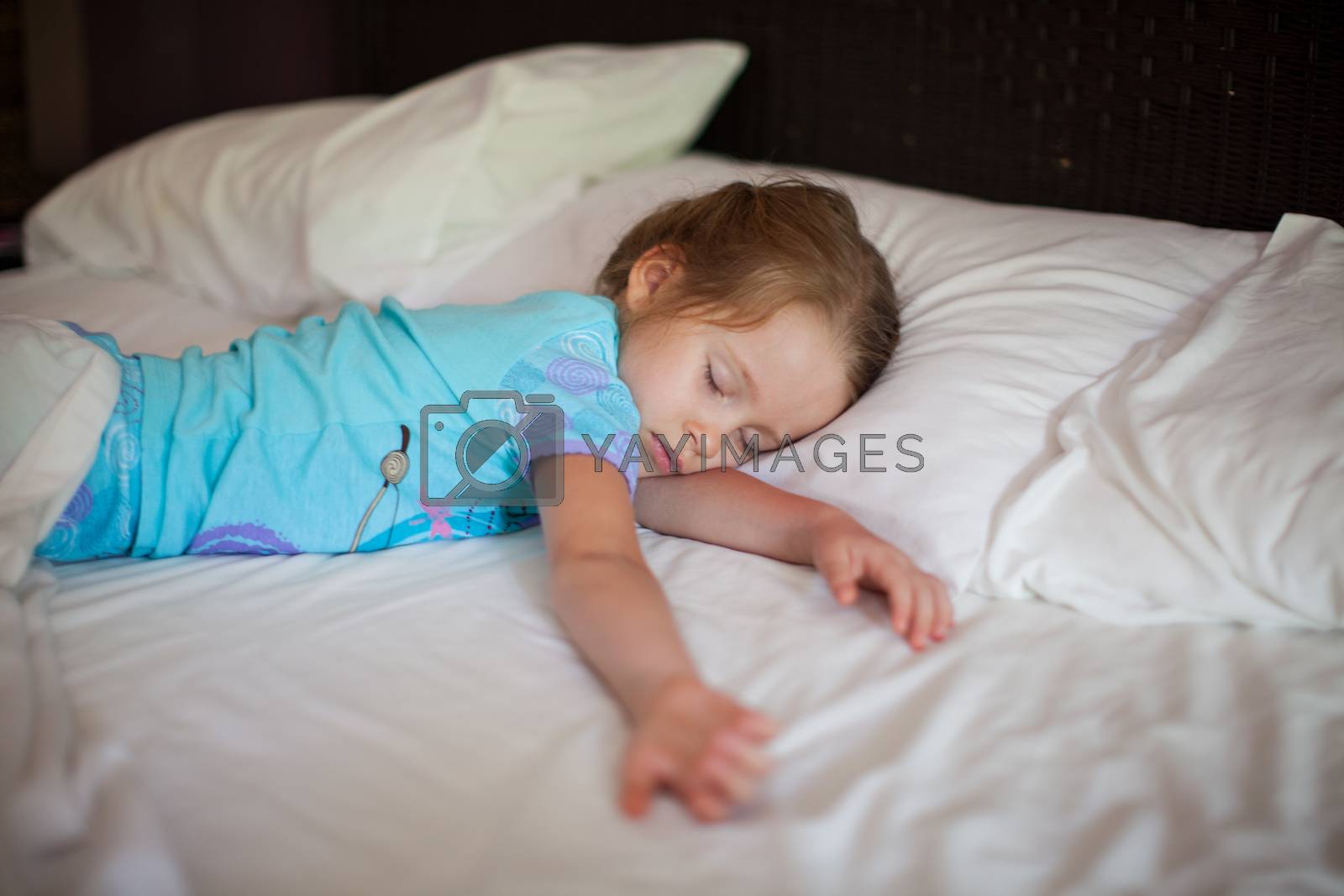 Royalty free image of Adorable toddler taking a nap by travnikovstudio