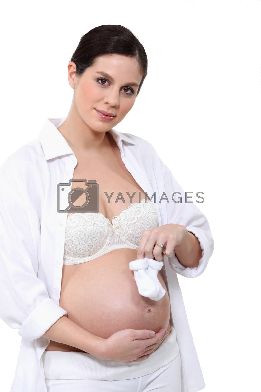 Royalty free image of Pregnant woman with a pair of bootees by phovoir