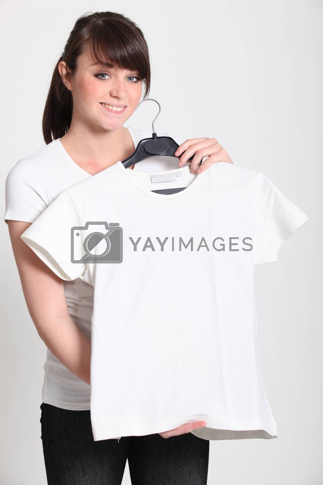 Royalty free image of Girl with a white t-shirt on a hanger by phovoir