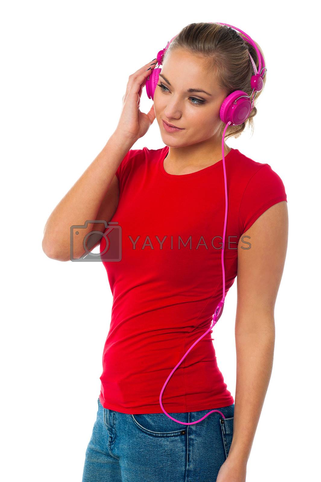 Royalty free image of Girl listening to music through headphones by stockyimages