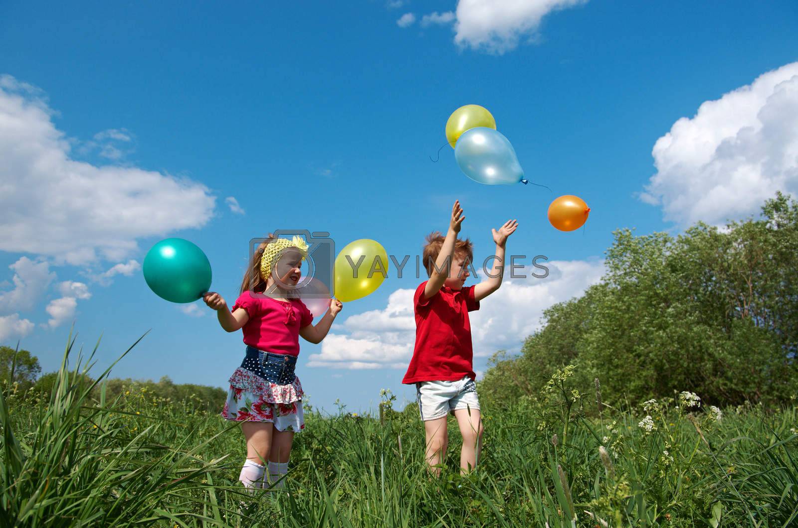 Royalty free image of children with balloon outdoor by Fanfo