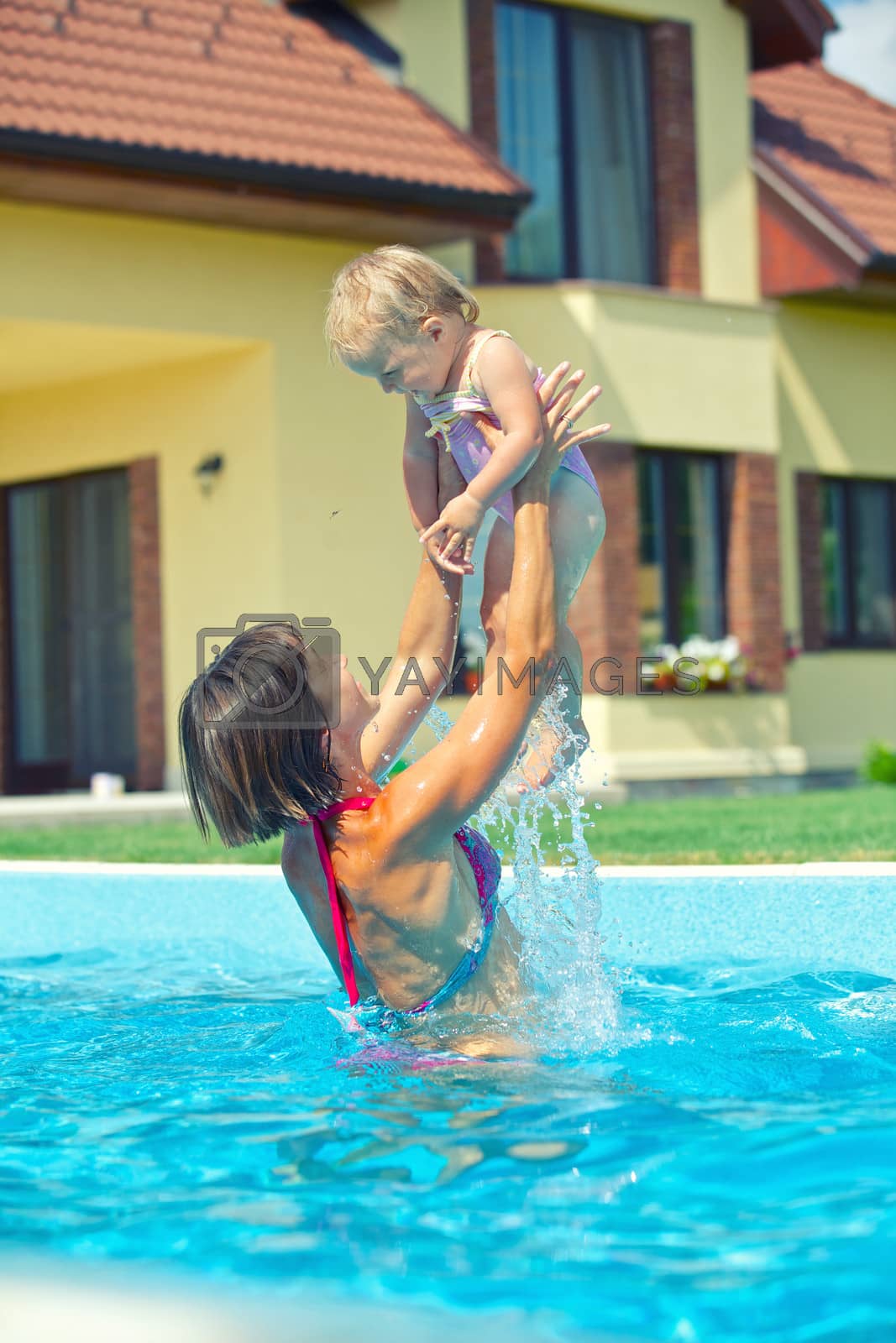 Royalty free image of Girl with mother in the pool by maxoliki