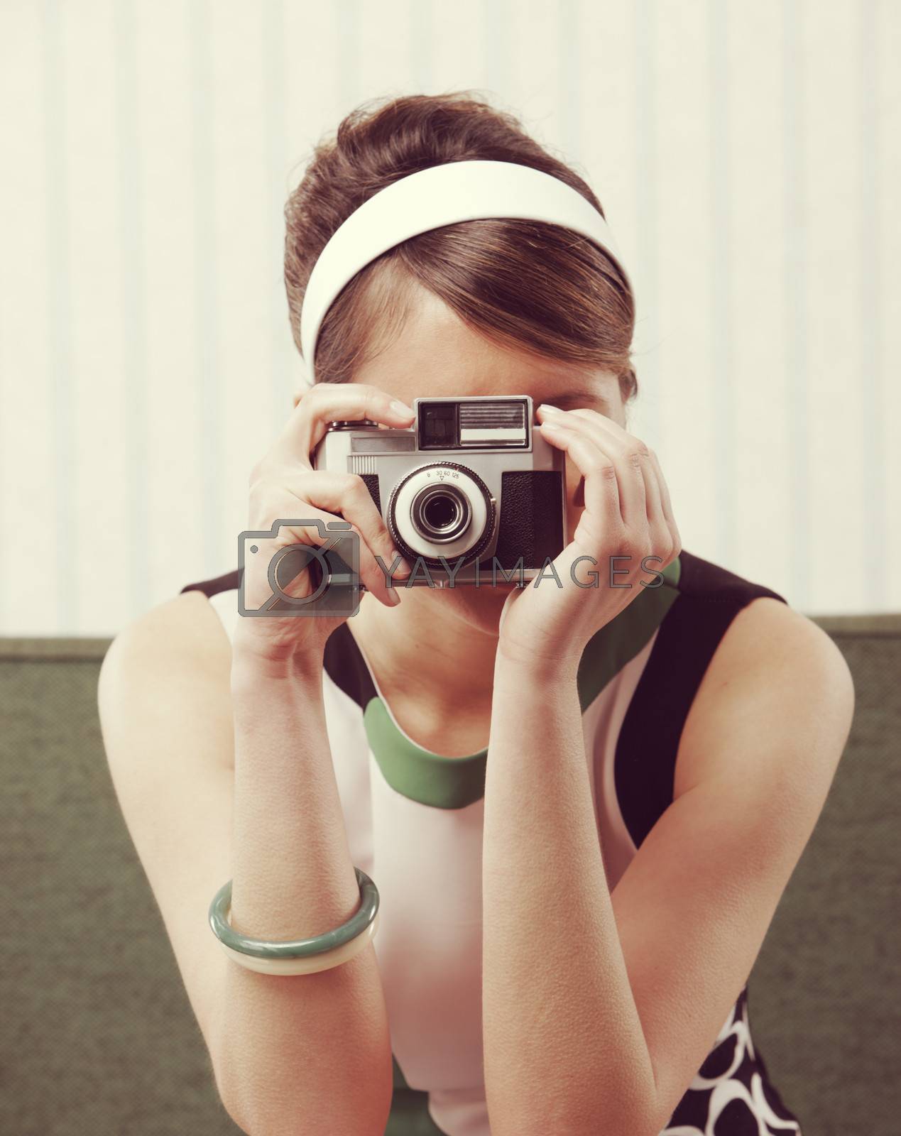 Royalty free image of Retro woman with old-fashioned camera by stokkete