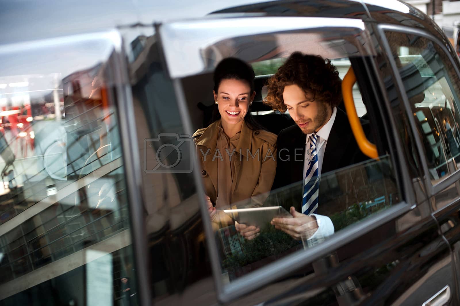 Royalty free image of Business people in taxi cab by stockyimages