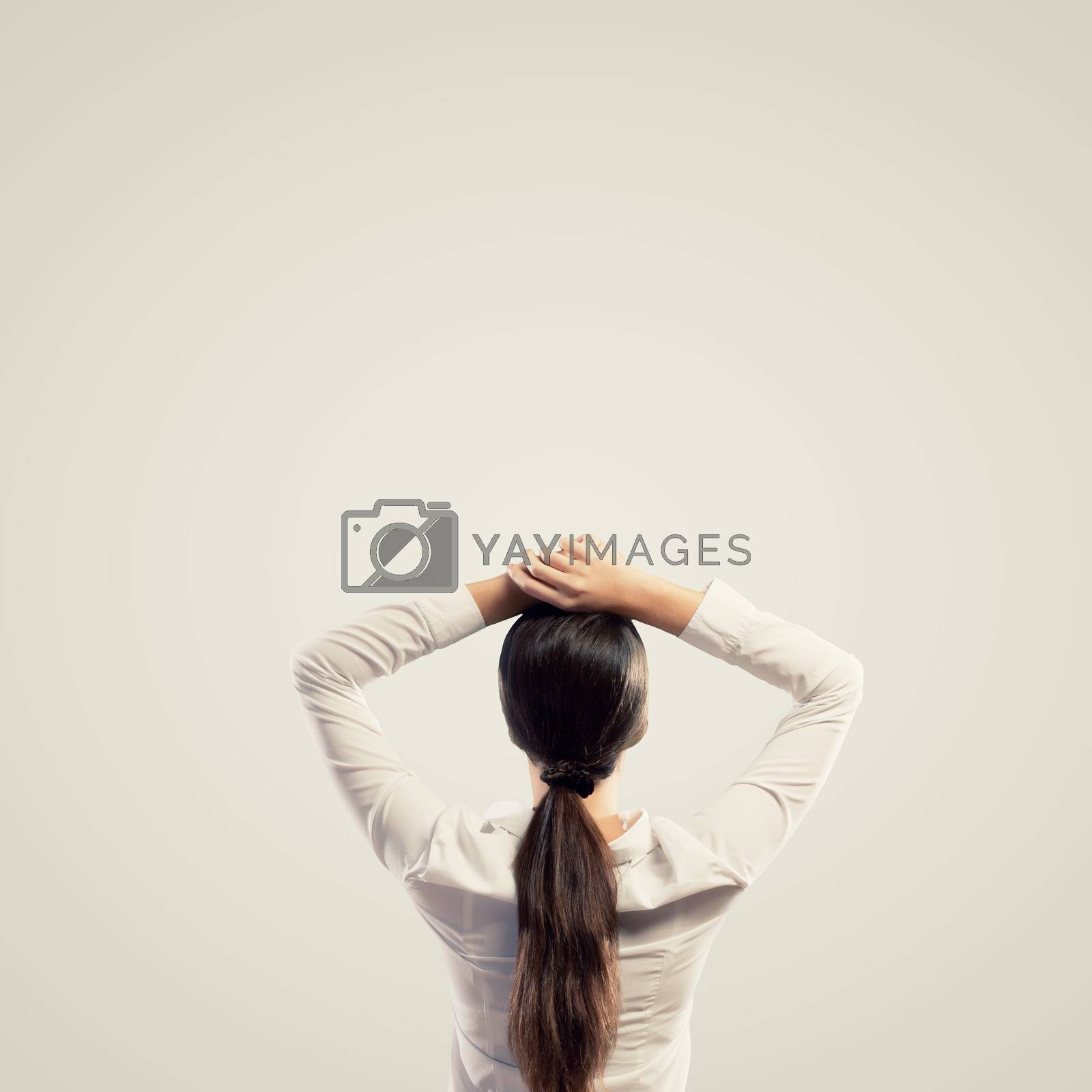 Royalty free image of Young woman standing with back by sergey_nivens