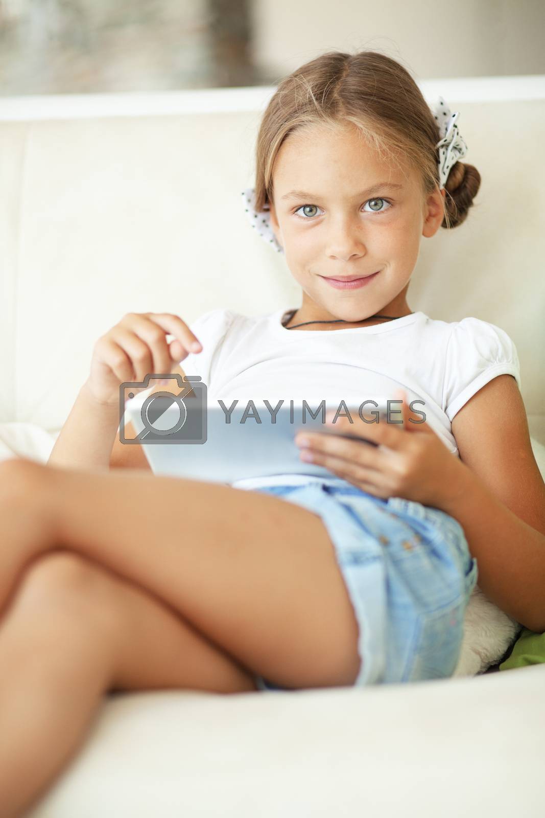 Royalty free image of Child playing on tablet pc by alenkasm