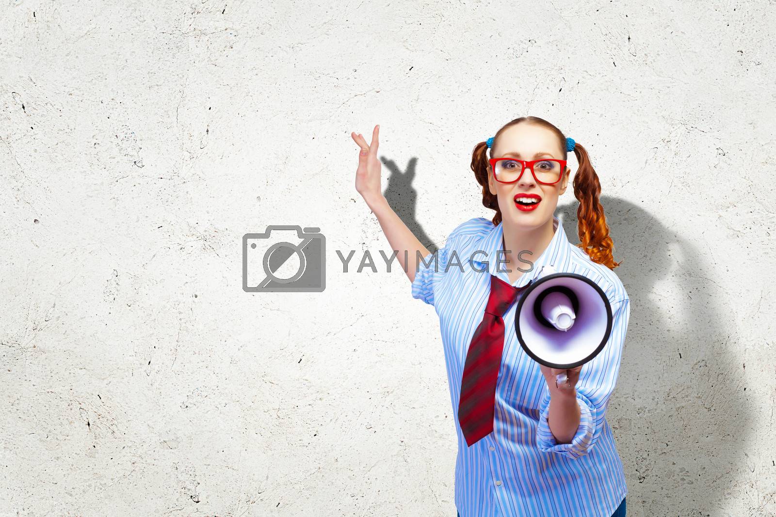 Royalty free image of Funny looking woman with megaphone by sergey_nivens