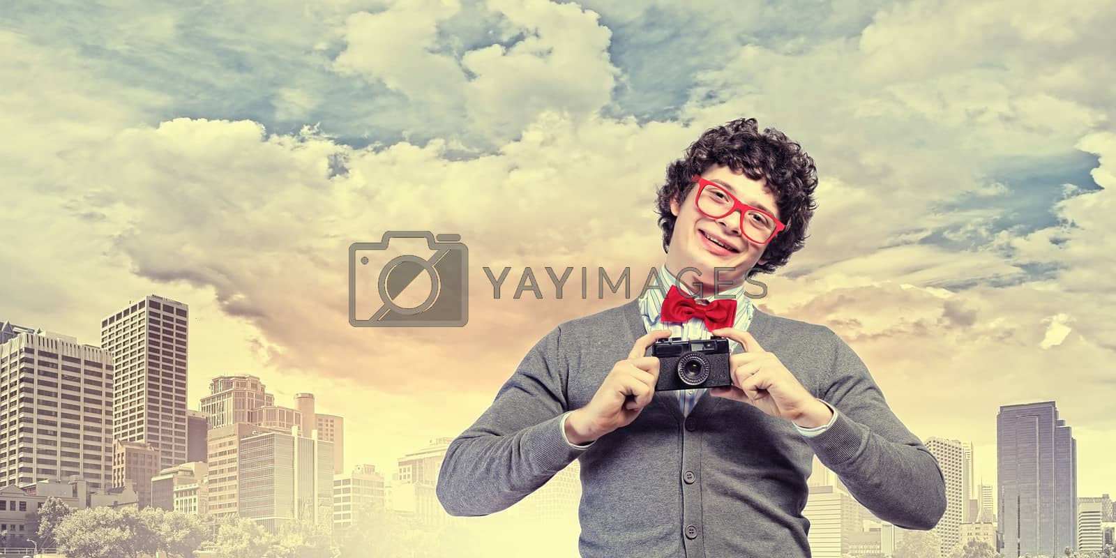 Royalty free image of Young man with photo camera by sergey_nivens