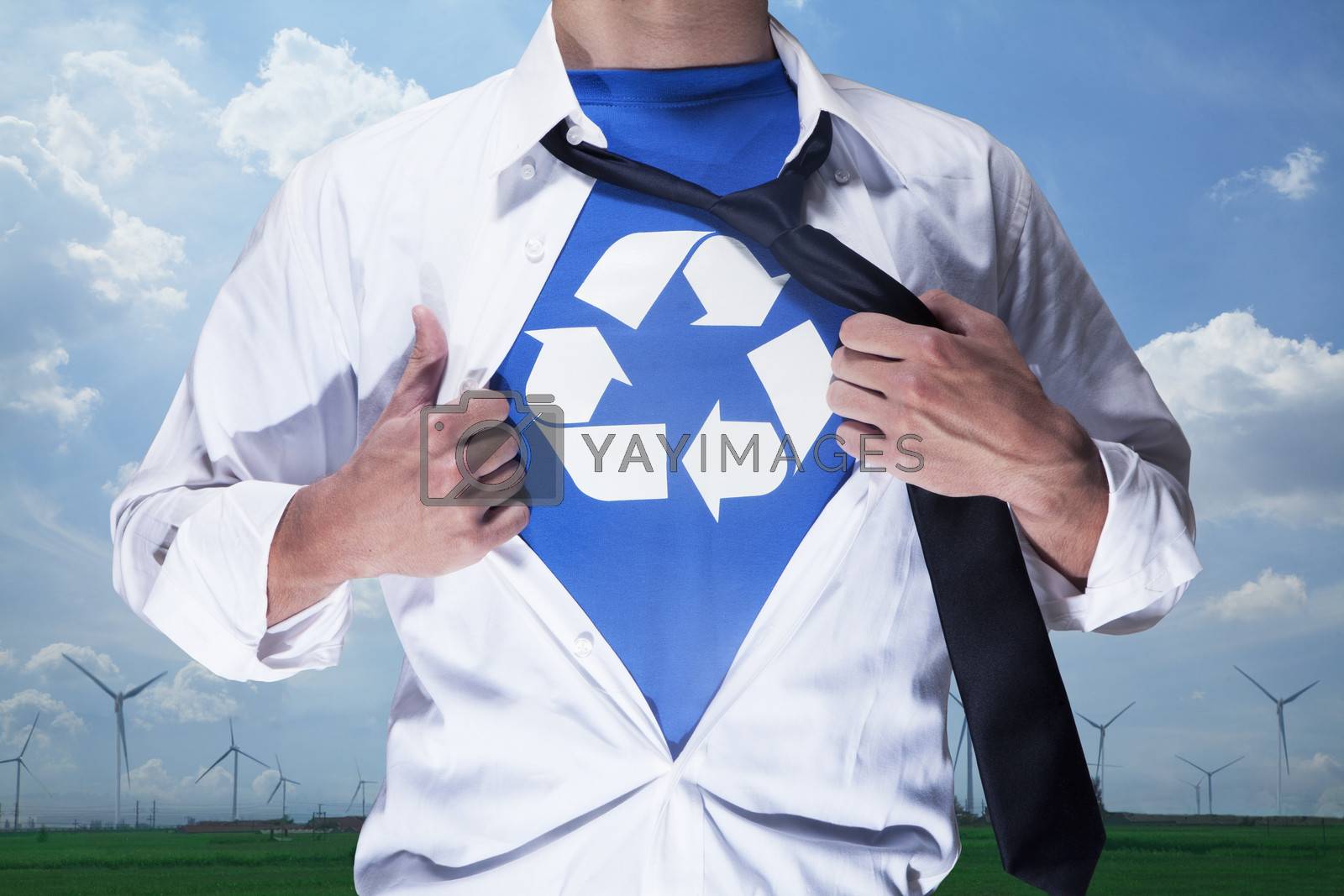 Royalty free image of Businessman with open short revealing shirt with recycling symbol underneath by XiXinXing