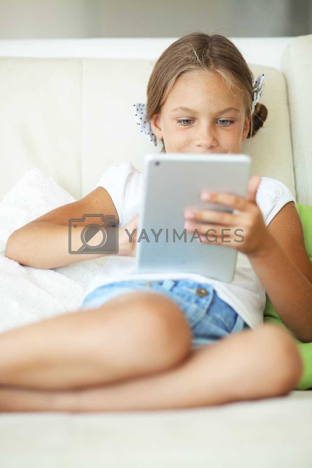 Royalty free image of Child playing on tablet pc by alenkasm