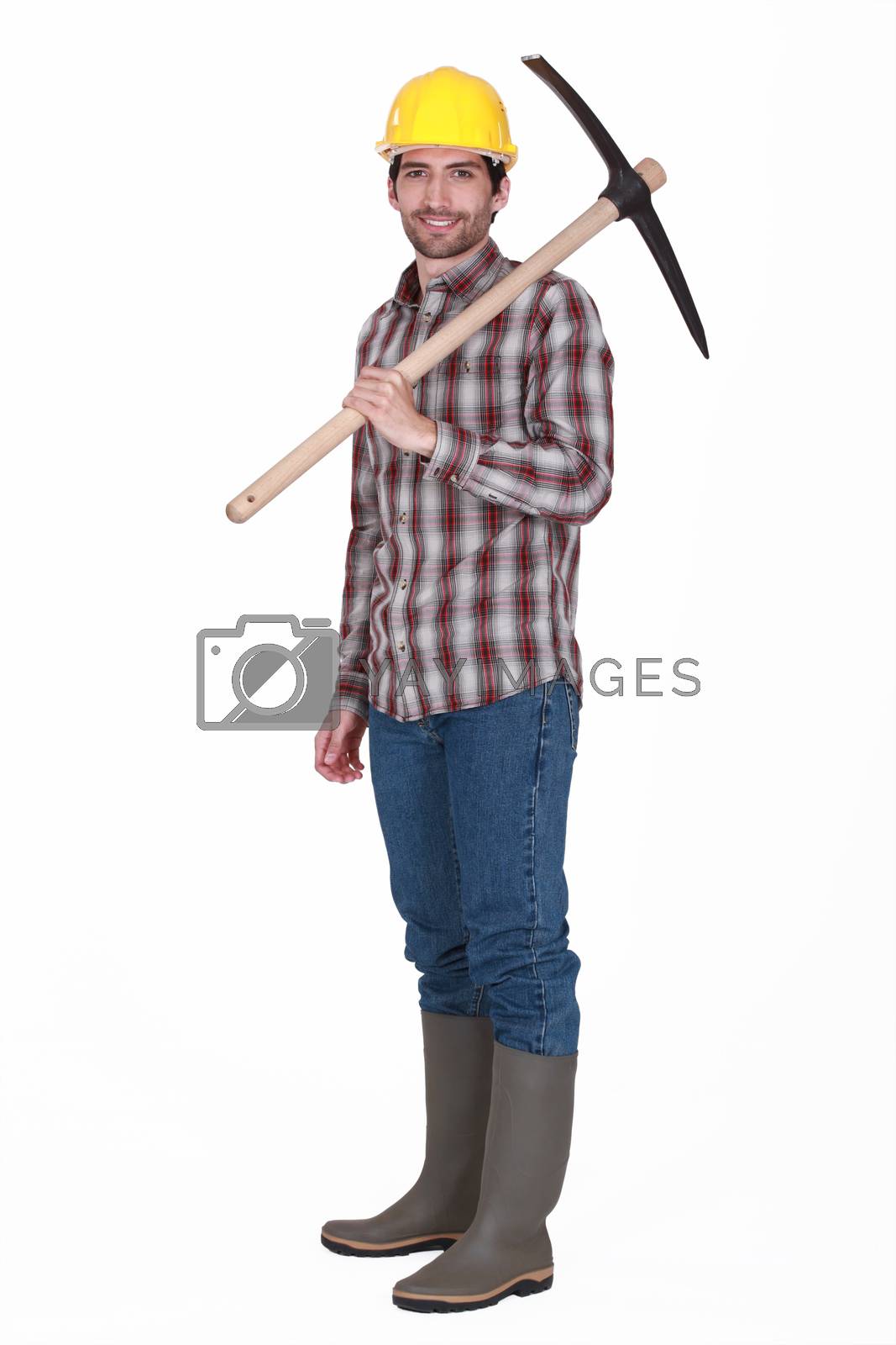 Royalty free image of Labourer carrying a pickaxe by phovoir