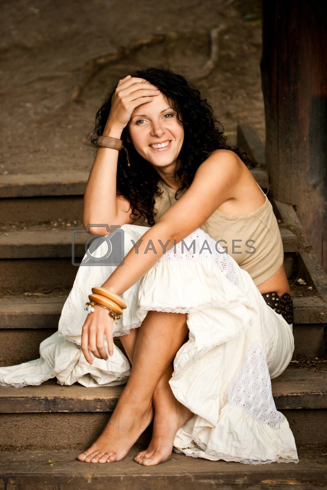 Royalty free image of woman sitting on wooden stairs by marylooo