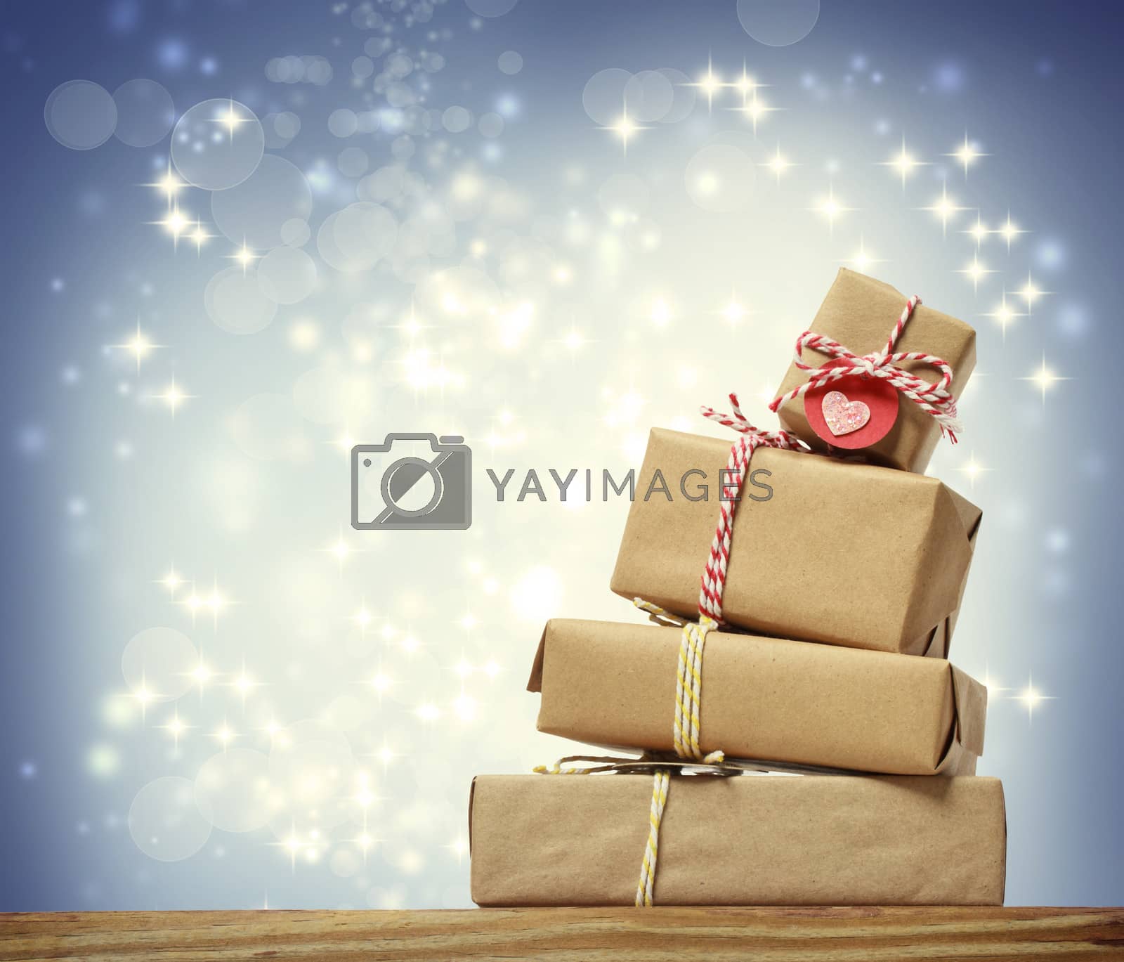 Royalty free image of Stack of handmade gift boxes over snowing night by melpomene