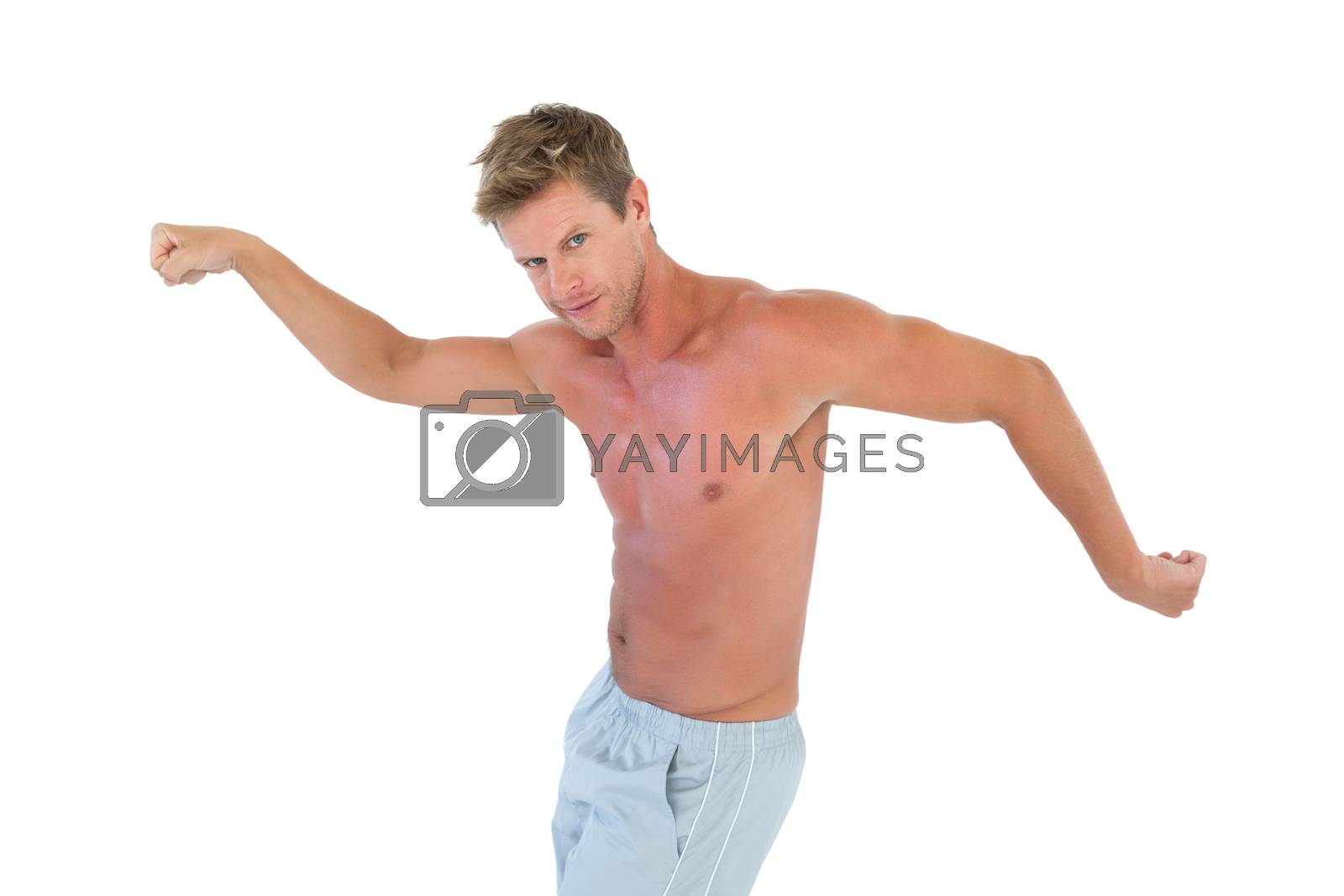 Royalty free image of Shirtless man gesturing and showing his muscles  by Wavebreakmedia