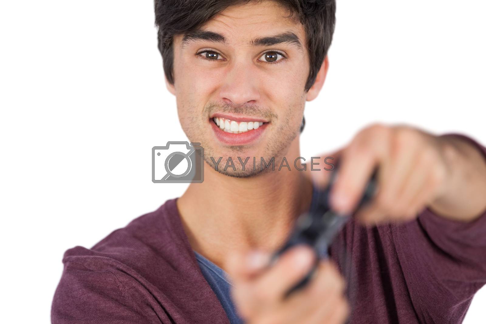 Royalty free image of Young adult playing video games by Wavebreakmedia