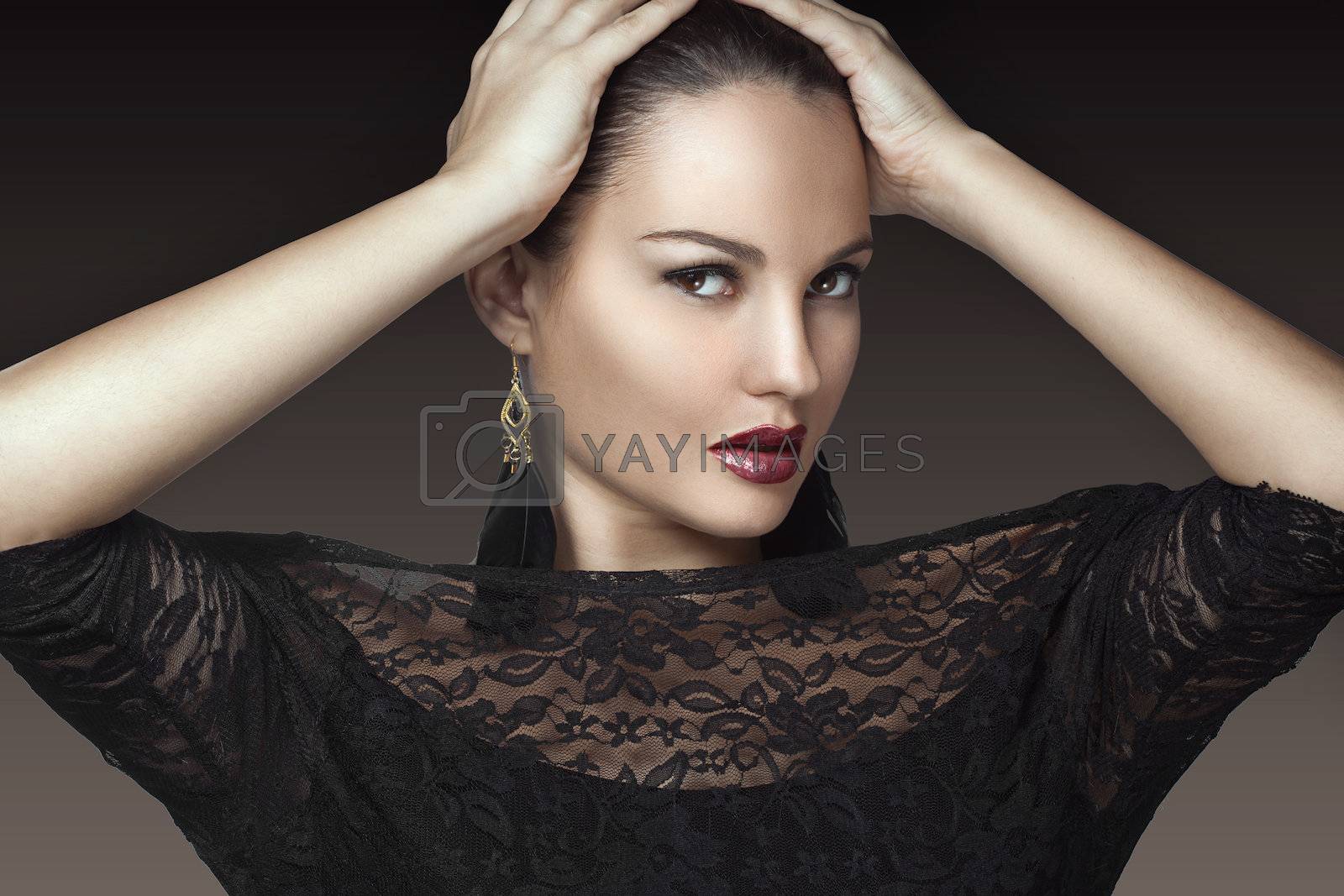 Portrait of beautiful woman with perfect make up over party lights