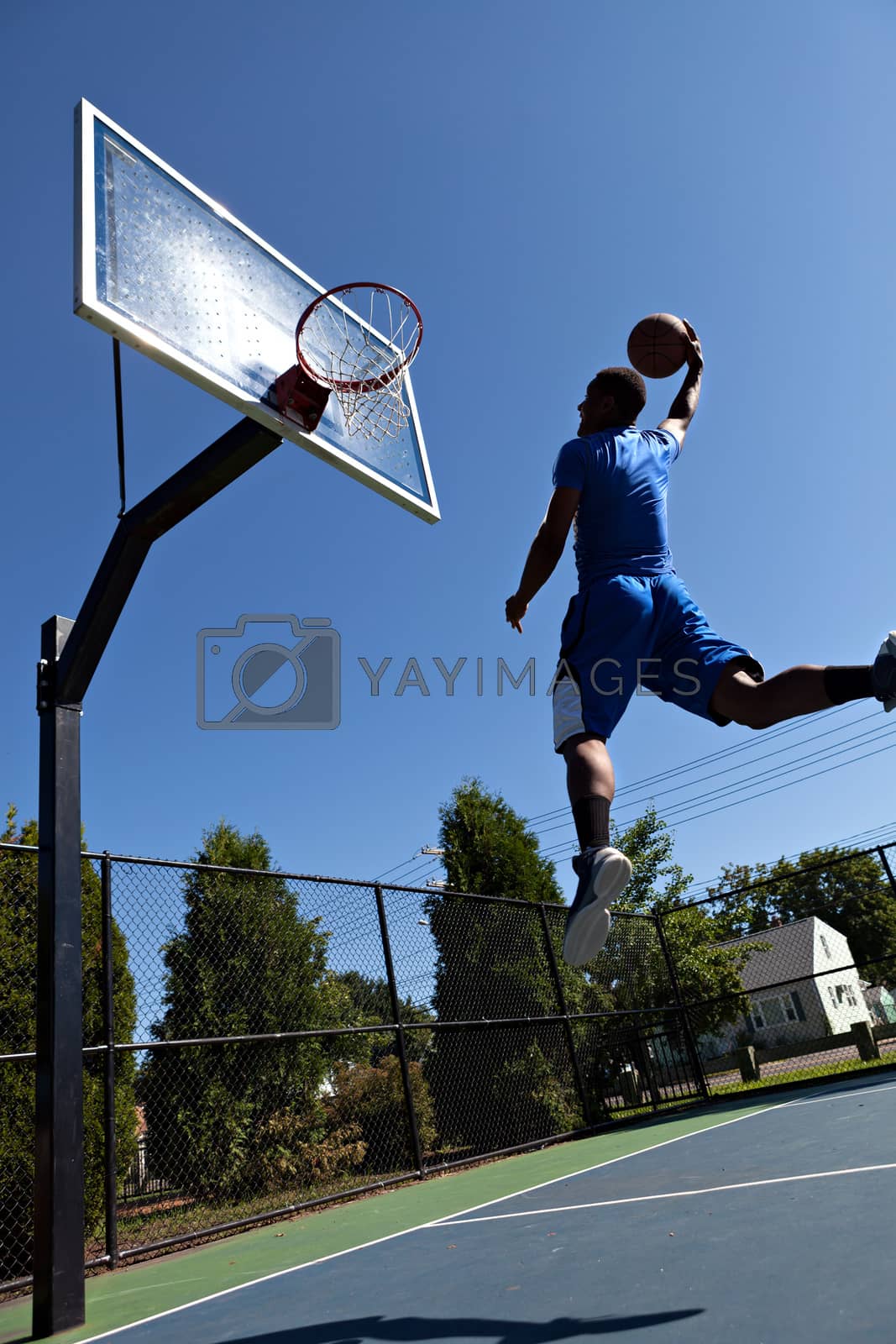Royalty free image of Man Dunking the Basketball by graficallyminded