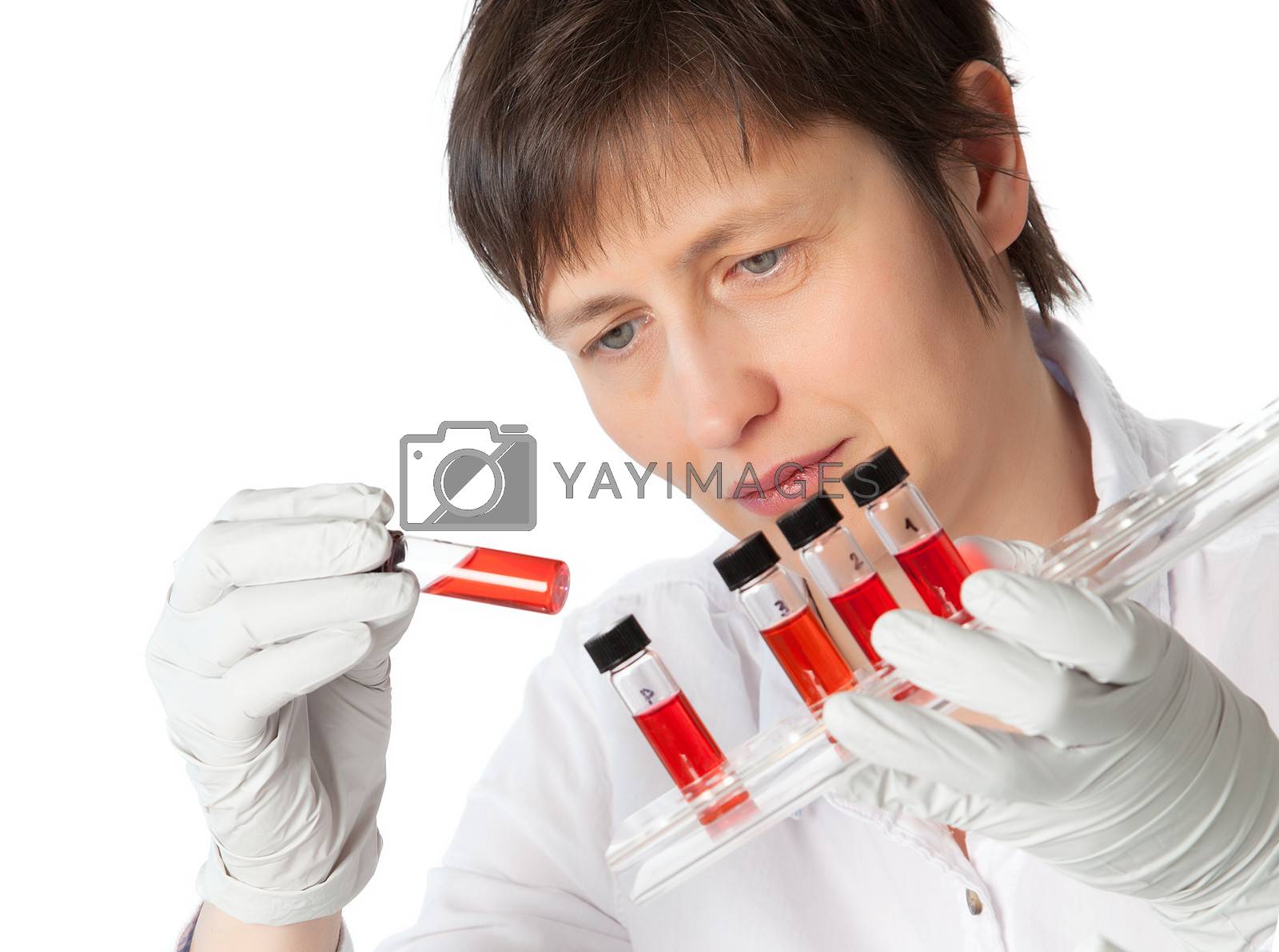 Royalty free image of Isolated scientist woman in lab coat with  liquid samples. by motorolka