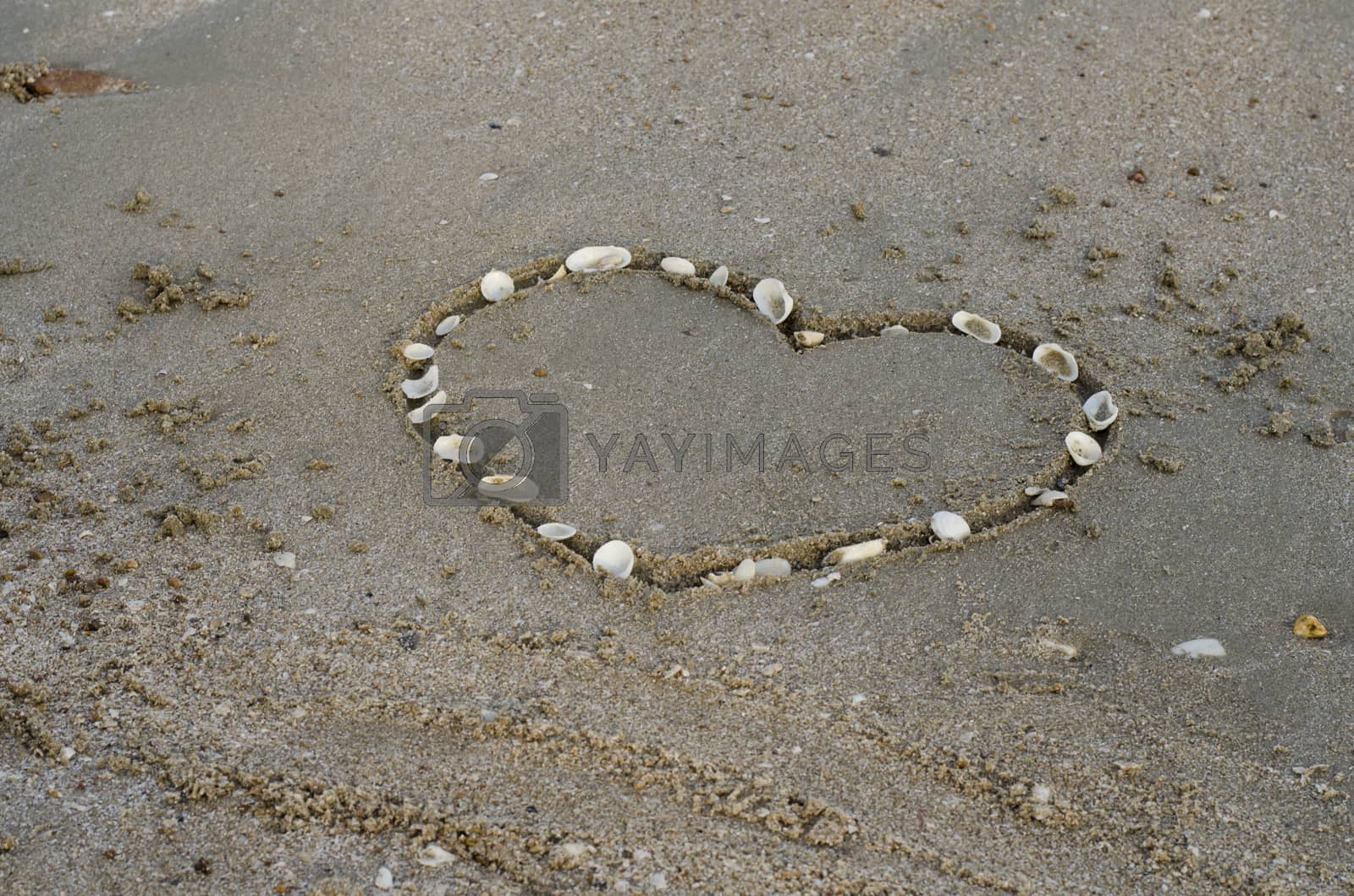 Royalty free image of a heart on the sand in the beach by ammza12