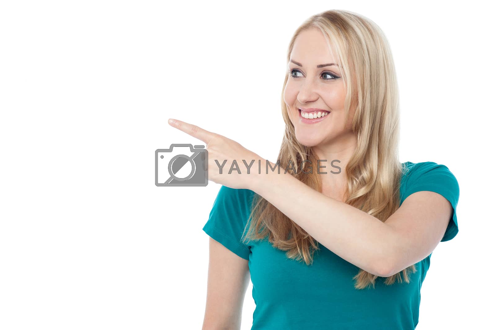 Royalty free image of Young woman pointing out right by stockyimages