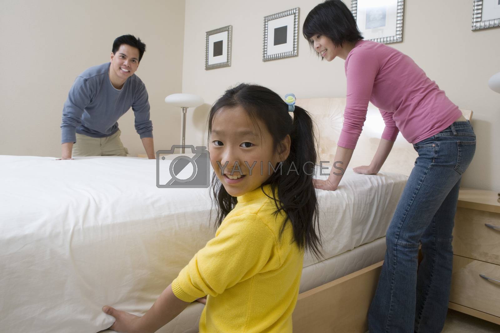 Family Preparing Bed Together