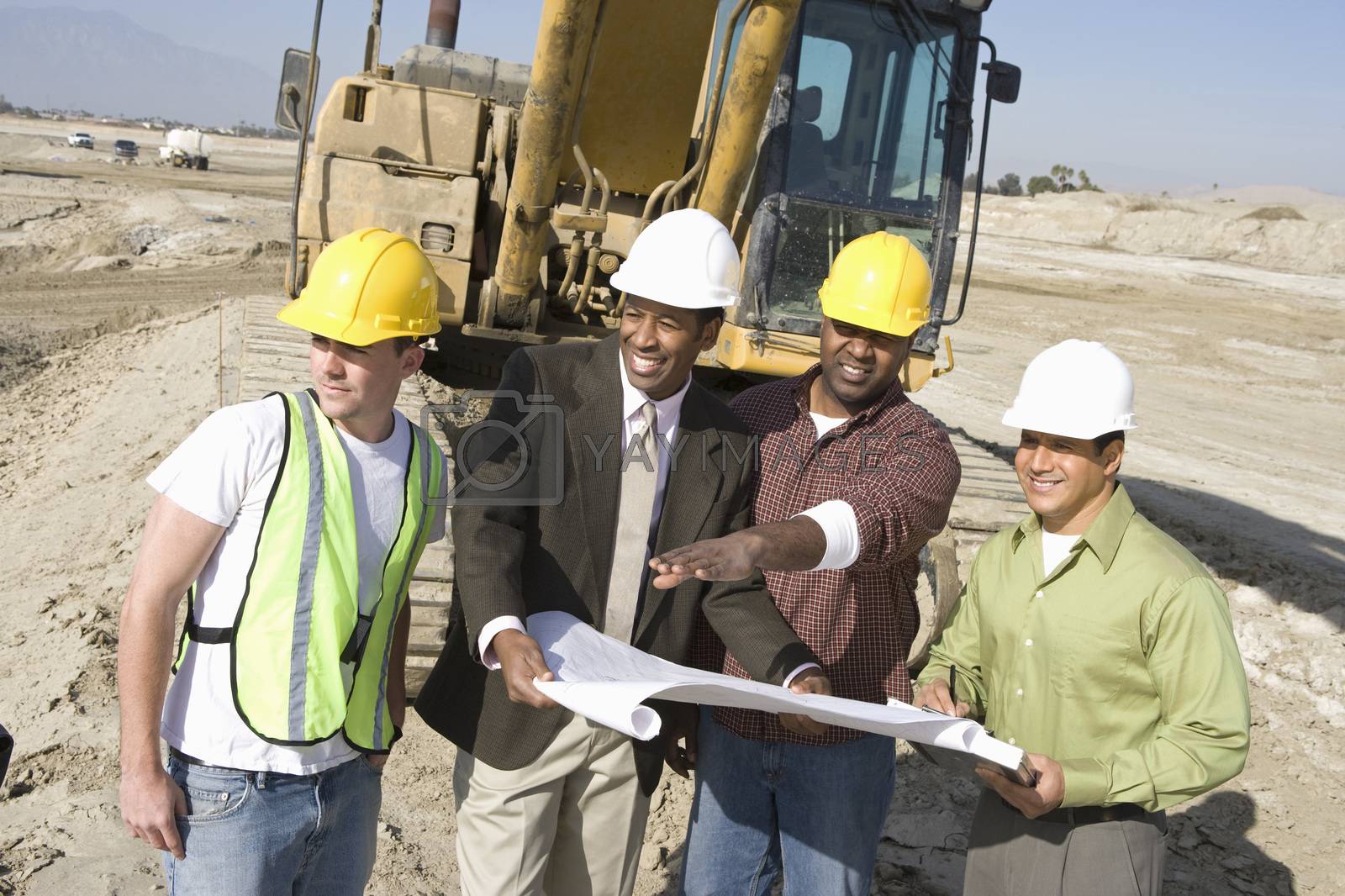 Royalty free image of Four architects in discussion with blueprint at construction site by moodboard