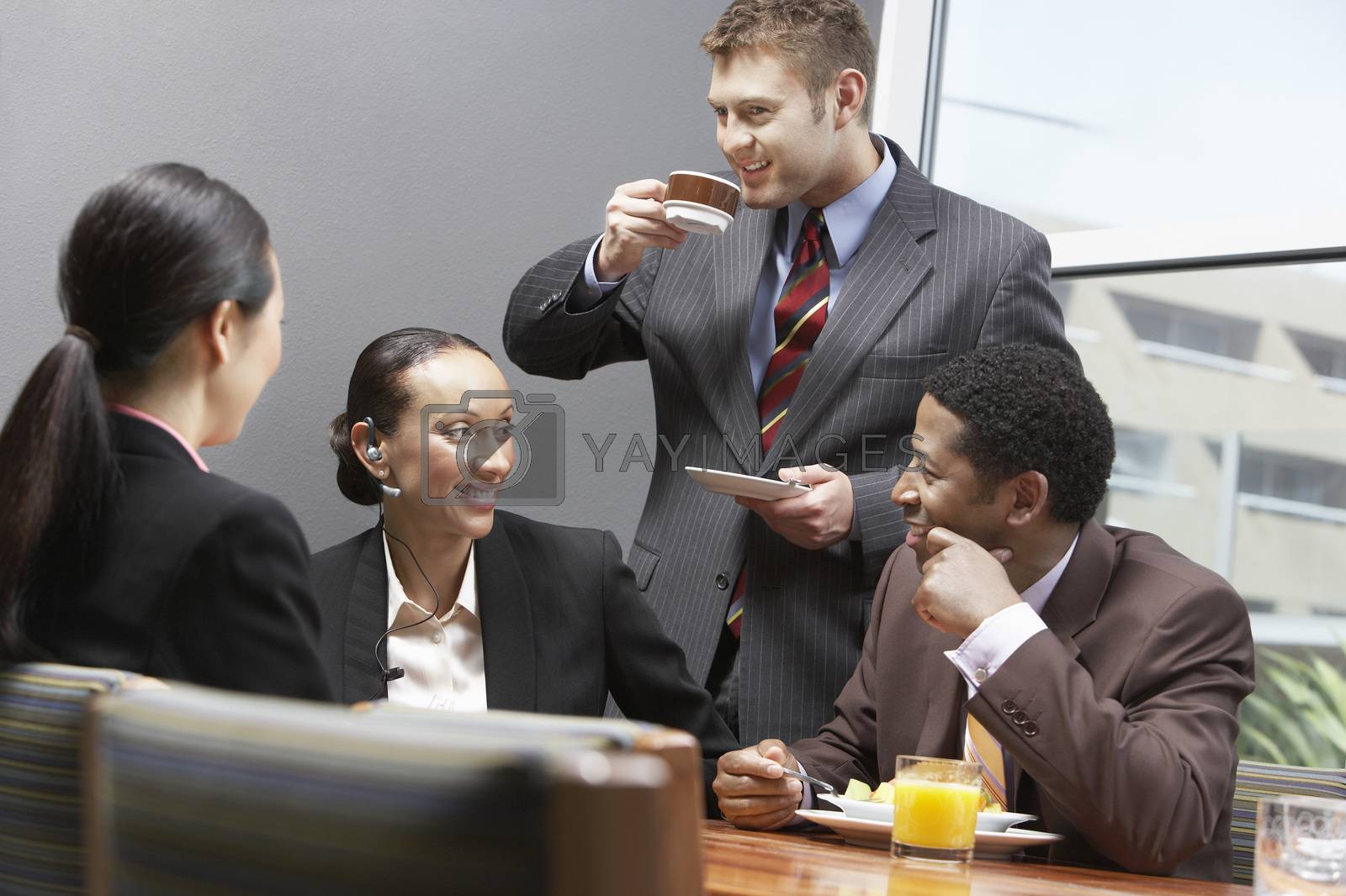 Royalty free image of Business team having a coffee break during their meeting at office by moodboard