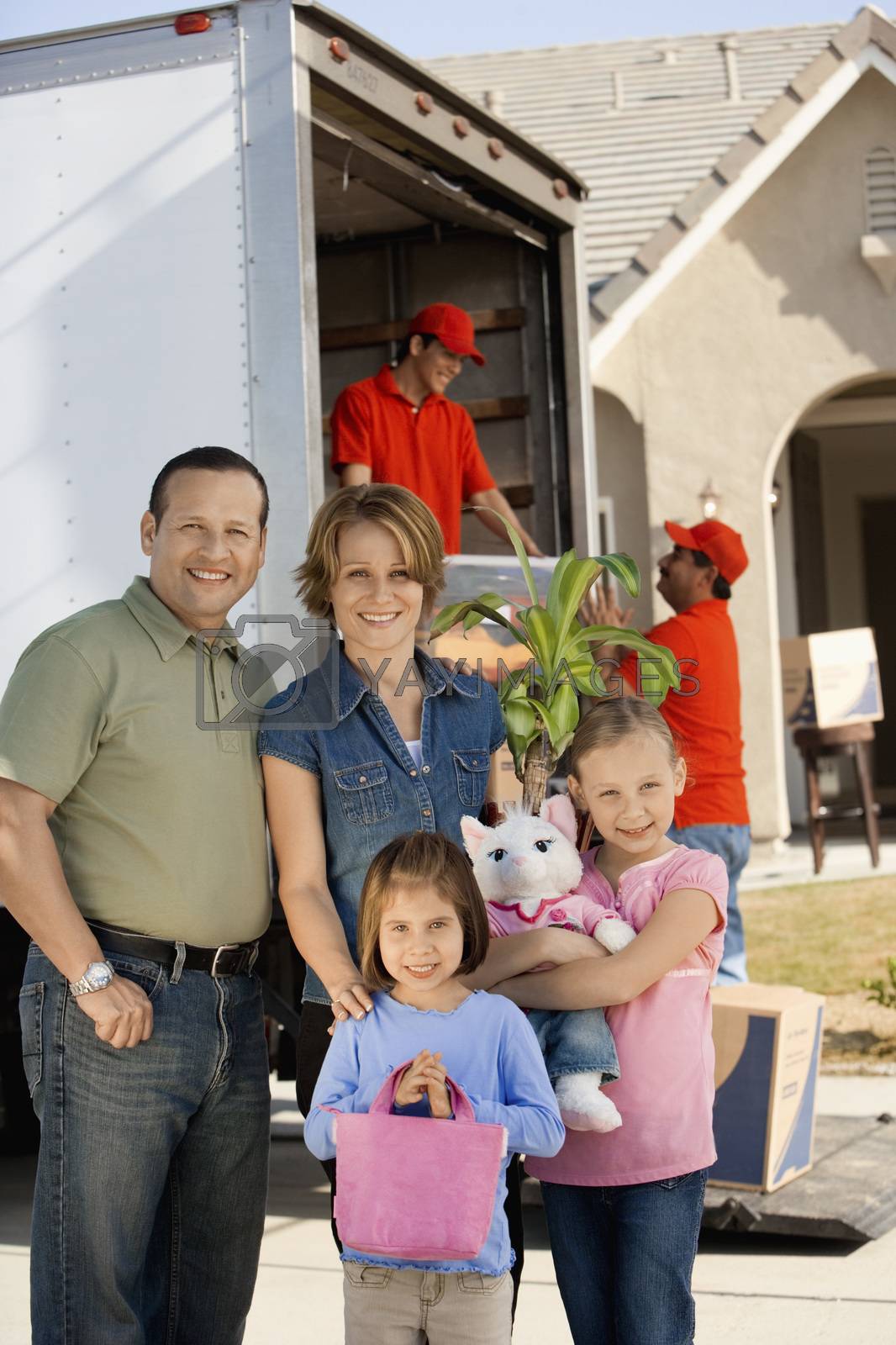 Royalty free image of Family in front of removal van and house portrait by moodboard