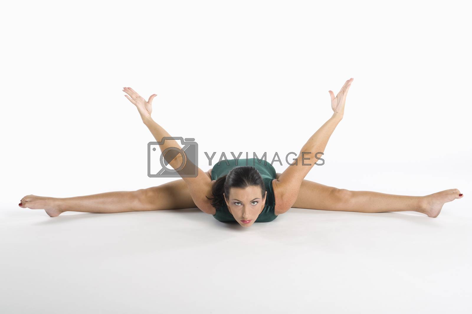 Royalty free image of Portrait of mid adult woman exercising over white background by moodboard