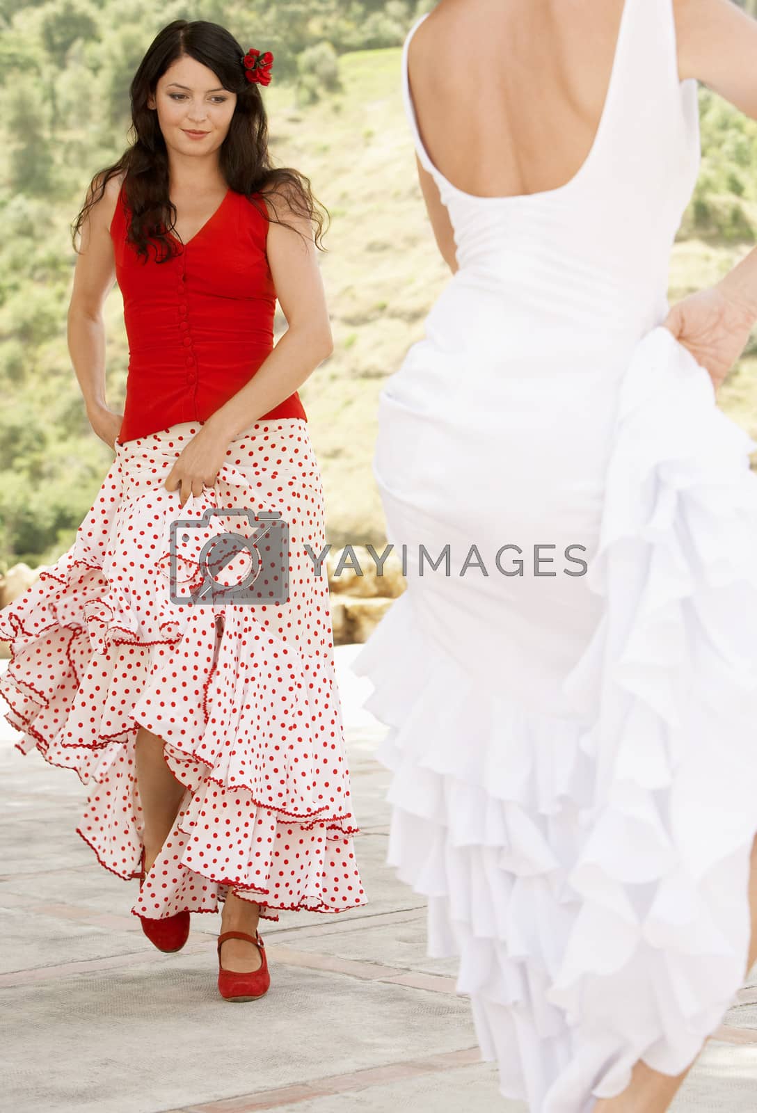 Royalty free image of Beautiful young women dancing flamenco outdoors by moodboard