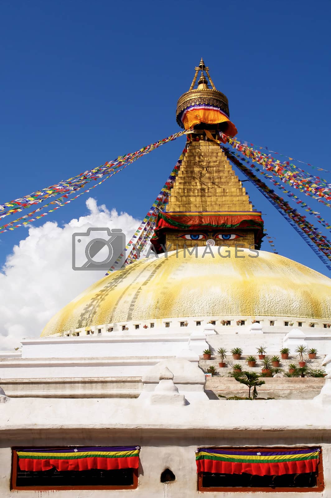 Royalty free image of stupa with buddha eyes and prayer flags on clear blue sky backgr by ptxgarfield