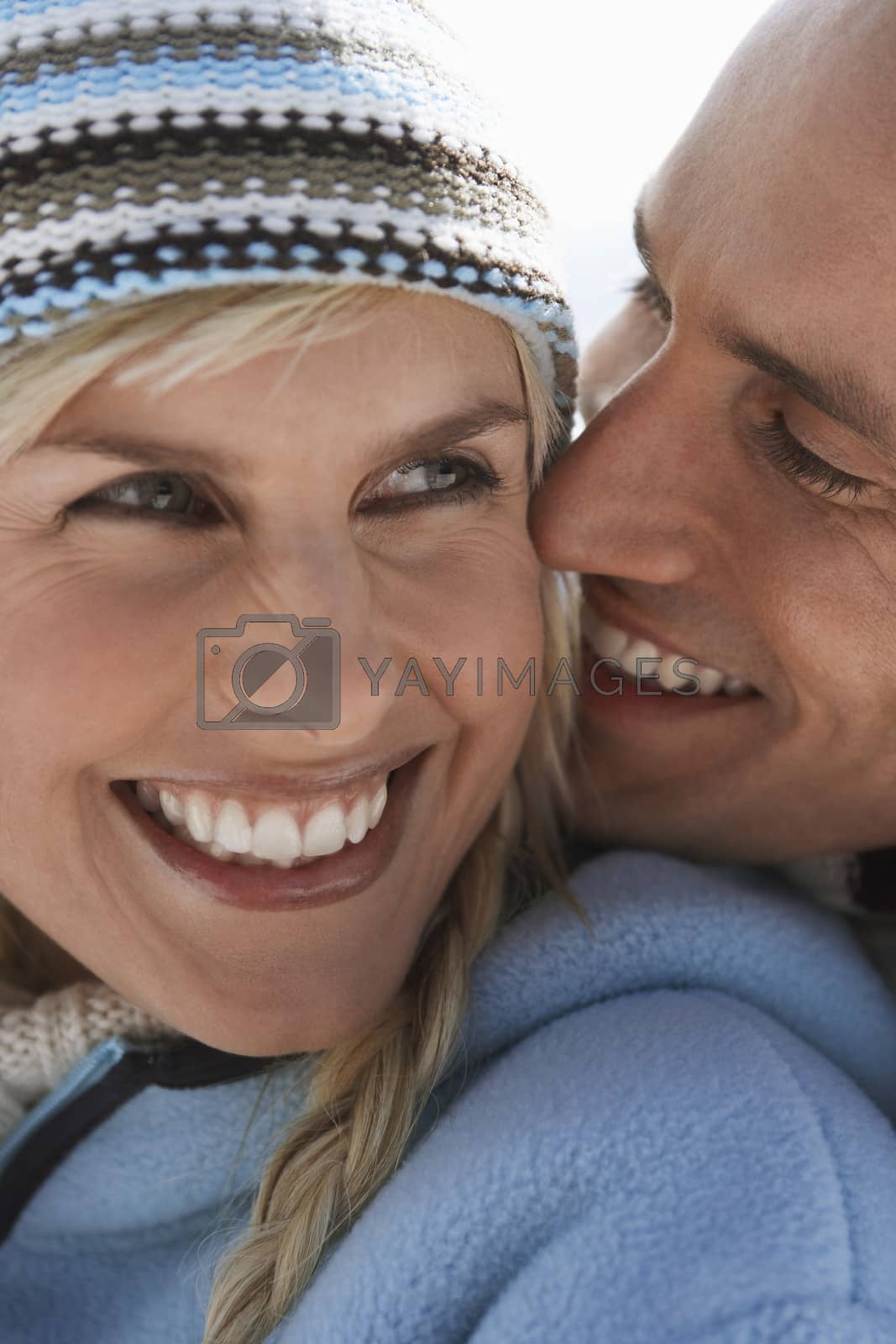 Royalty free image of Couple embracing on mountain peak close-up portrait by moodboard