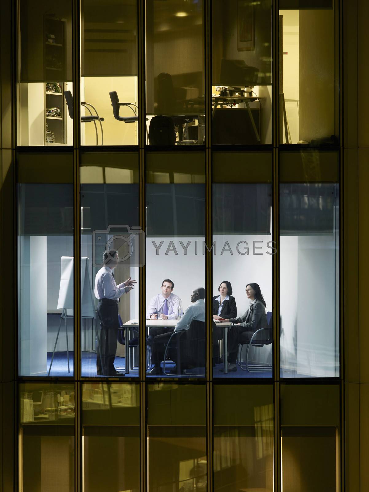 Royalty free image of Group of business people at meeting in office view from building exterior by moodboard